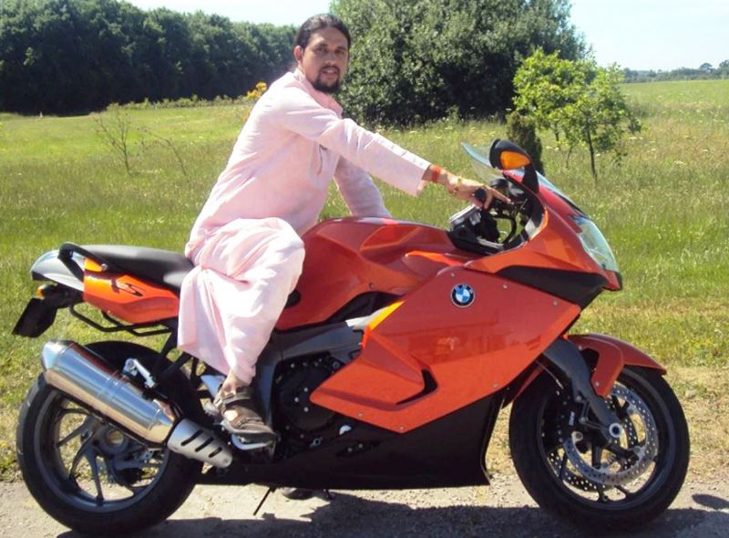 Anand Giri riding a luxury bike