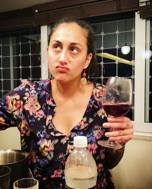 Karuna Ezara Parikh with a glass of wine
