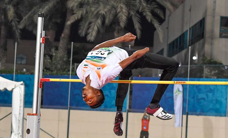 Nishad Kumar while performing a high jump