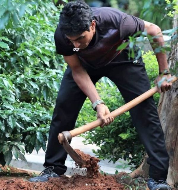Pramod Bhagat planting a tree
