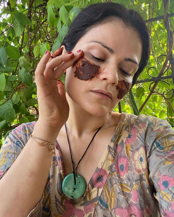 Vasudha Rai while applying a beauty product on her face
