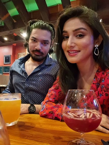Donal Bisht drinking wine with her brother
