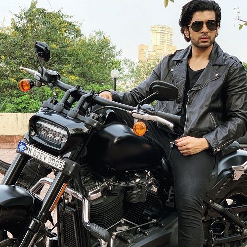 Karan Kundrra posing on his motorcycle