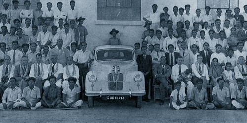 Old picture of Hinduja brothers (standing with car) after their deal with Ashok Leyland