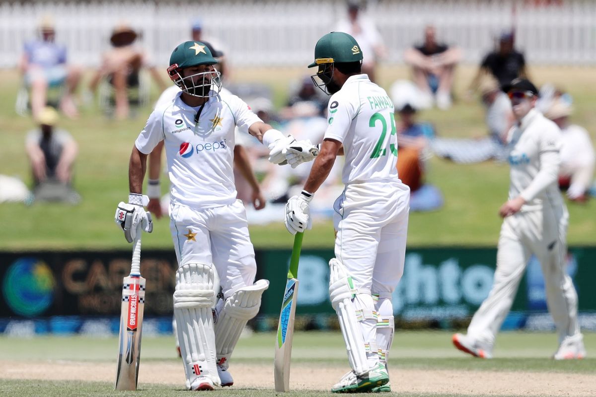 Rizwan and Fawad Alam punching their gloves during the second inning