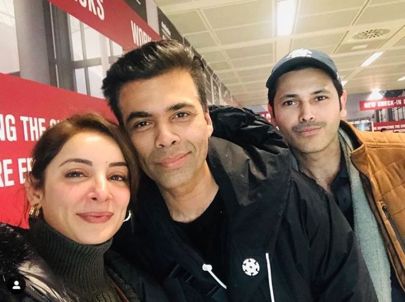 Sarwat Gilani and her husband posing for a selfie with Karan Johar