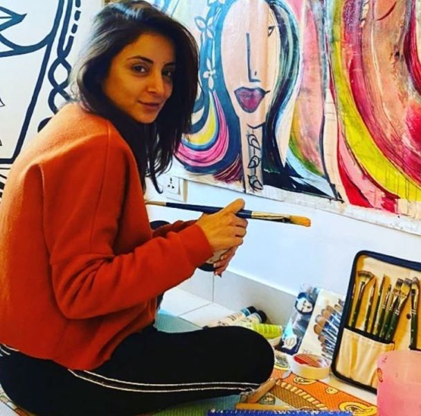 Sarwat Gilani painting a canvas