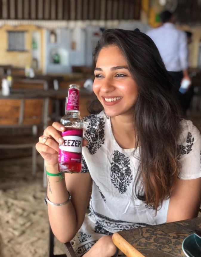 Vidhi Pandya with a bottle of alcohol