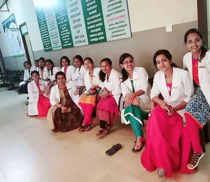 Anjana Shajan (sitting second from right) as a doctor at KMCT Medical college and hospital