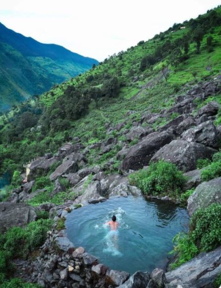 Photo of man swimming in a water stream