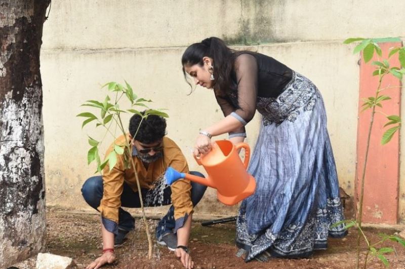 Ravi Kiran and his wife while planting the trees at their home