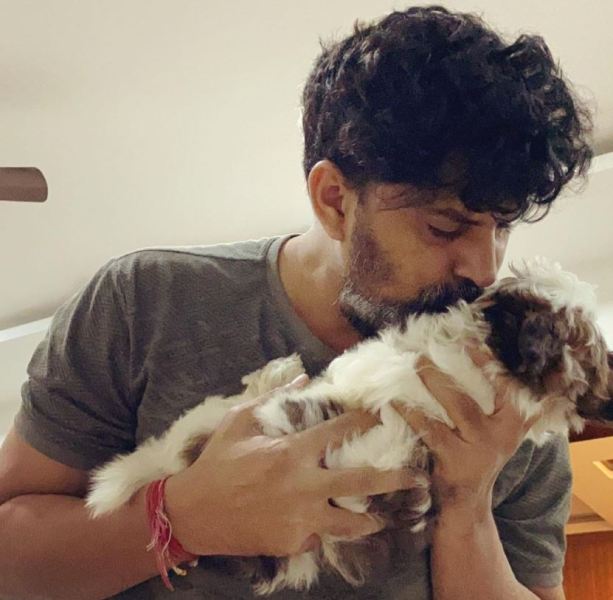 Ravi Kiran while kissing his pet dog
