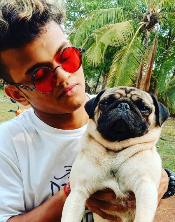 Sanket Gaonkar posing with his pet dog