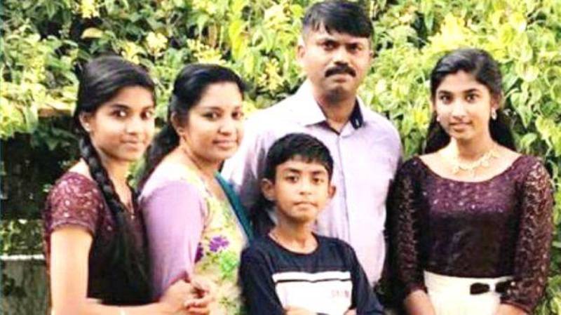 Sibi Thomas with his wife, two daughters, and a son