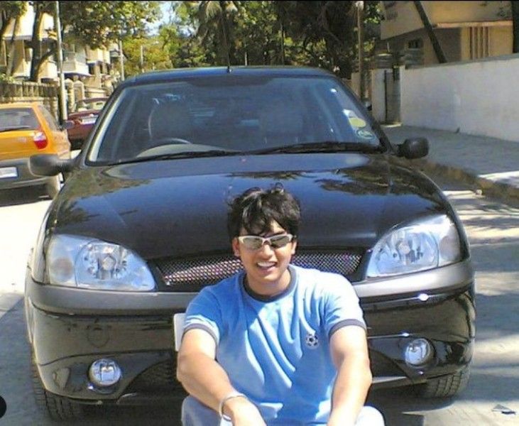 Chirag posing with his Renault Scenic car