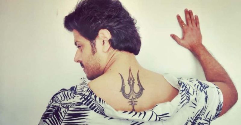 Neil Bhatt featuring his tattoo on his back