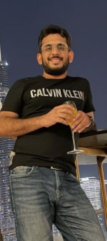 Aman holding a glass of wine