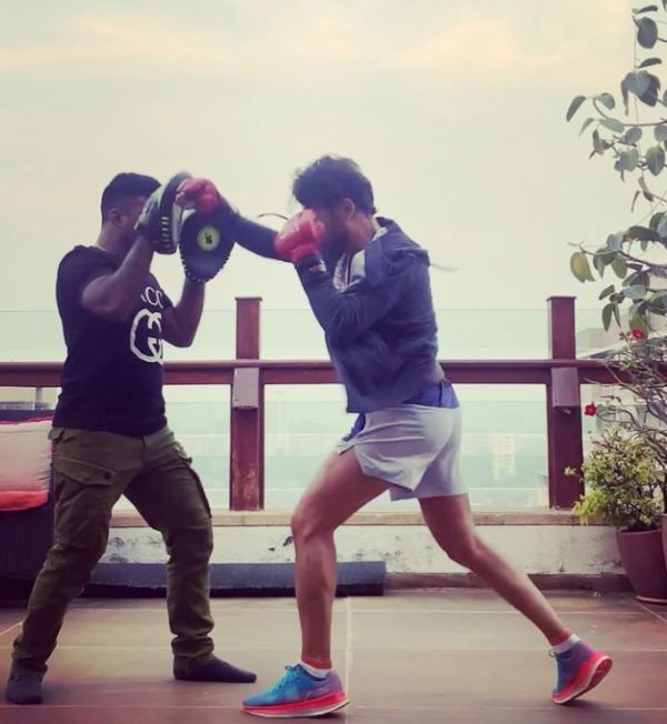 Anupam Mittal (right) while practicing boxing