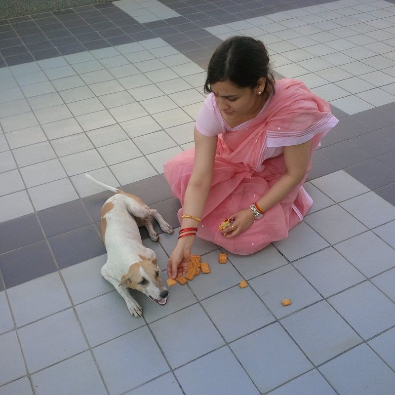 Aparna playing with a dog