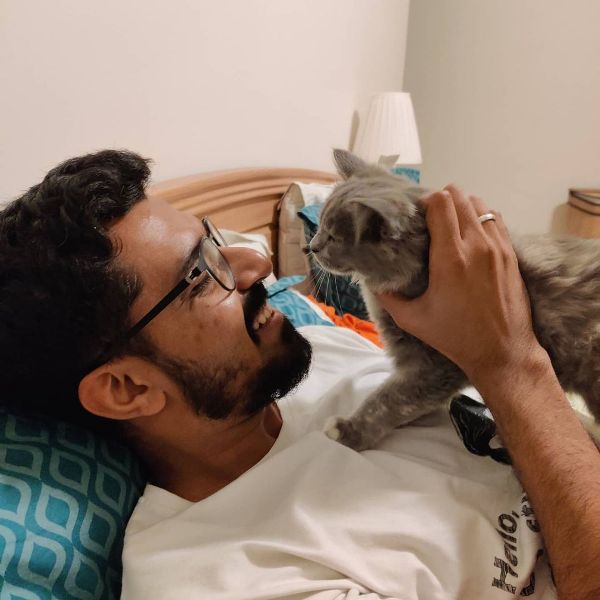 Azeem Banatwalla playing with his pet cat
