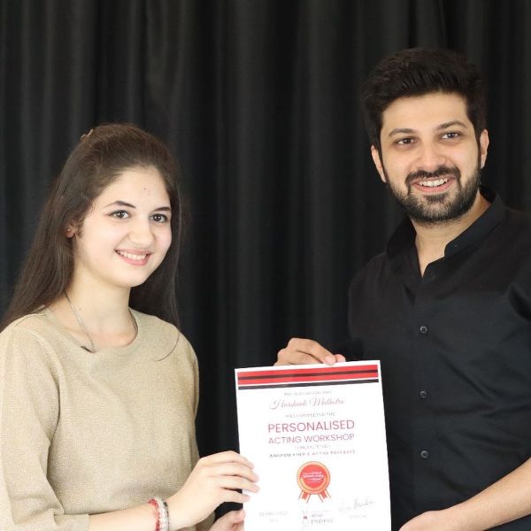 Harshaali Malhotra while receiving a certificate for completing the Personalised Acting Workshop conducted by Anupam Kher's Actor Prepares