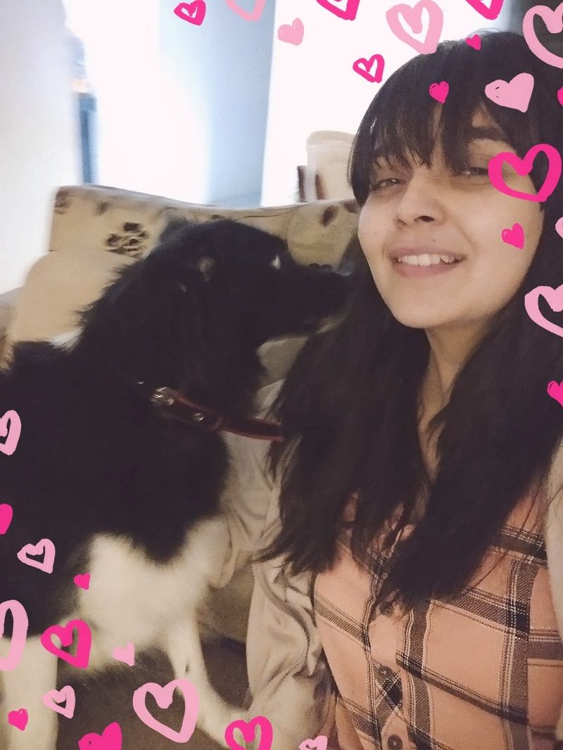Mansi posing with a dog