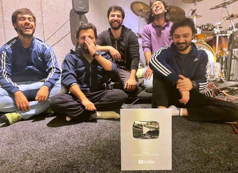 Members of the band Bayaan posing with its Silver Creator Award in 2022