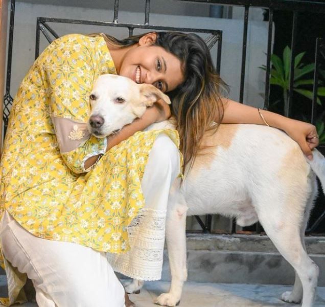 Anjali Arora cuddling with her pet dog