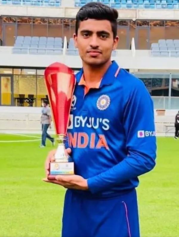 Dinesh Bana holding Under 19 Asia Cup trophy