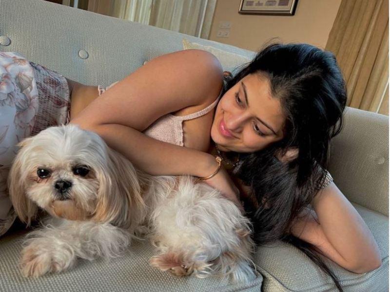 Zanai Bhosle posing with her pet dog