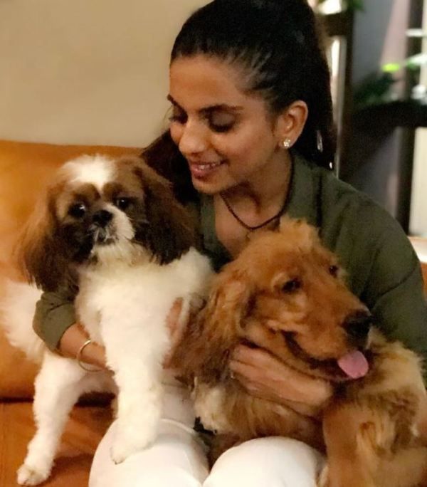 Deepti Tuli cuddling with pet dogs