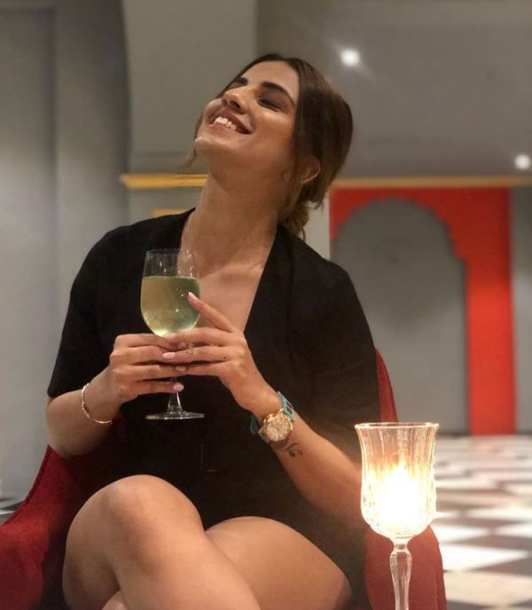 Deepti Tuli drinking a glass of Champagne