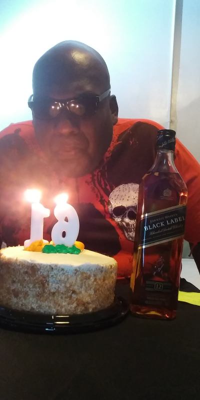 Frank R James celebrating his 61st birthday with a bottle of Black Label