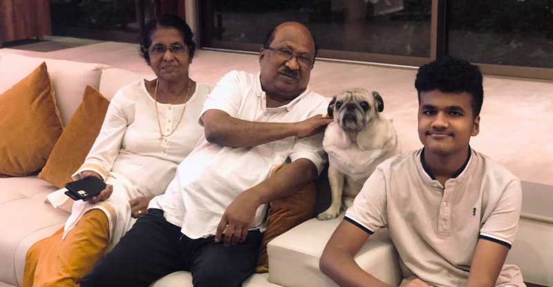 K. V. Thomas with his wife, Sherly Thomas, grandson, and dog, Archie