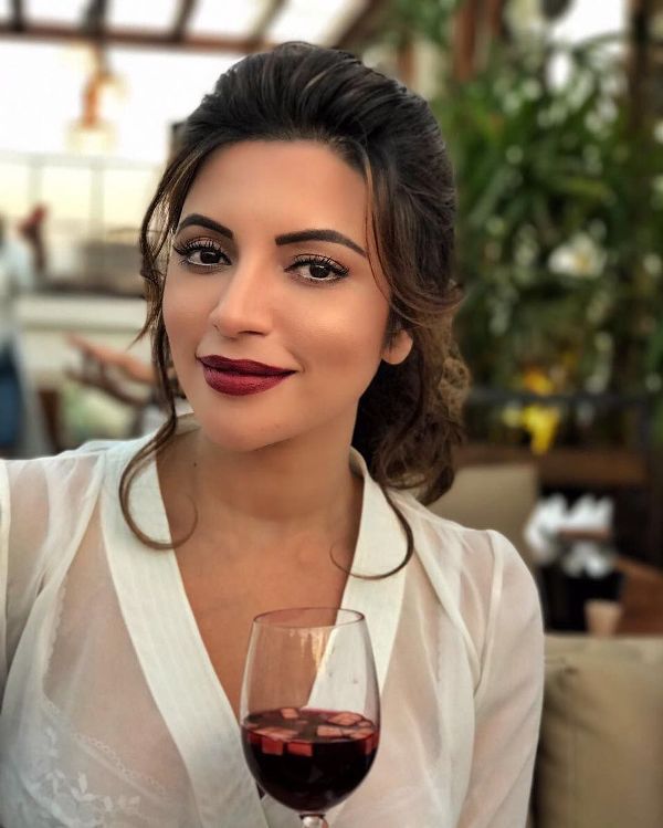 Shama Sikander holding a glass of wine