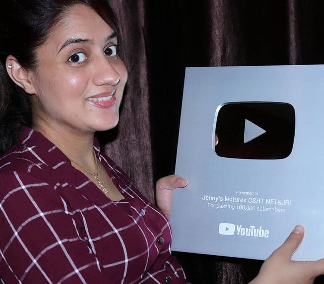 She showing the silver button she received from YouTube