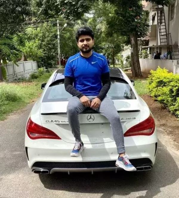 Adil Khan Durrani sitting on the trunk of his car