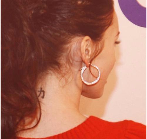 Chinese symbol of strength tattoo at the back of Fox's neck