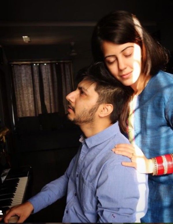 Divya Harjai with her husband learning to play the piano