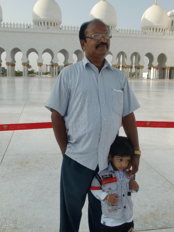 Edava Basheer standing with a child