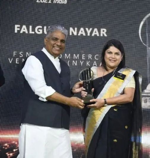 Falguni Nayar posing with her EY Entrepreneur of the Year Award