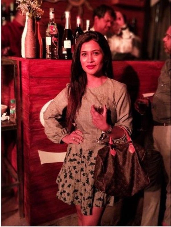 Ruchita Jadhav holding a glass of wine
