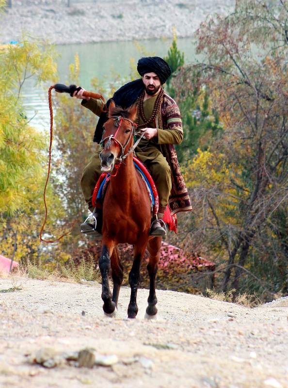 Ajmal Haqiqi riding a horse