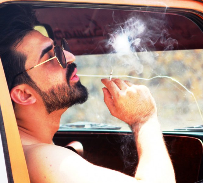 Ajmal Haqiqi smoking a cigarette