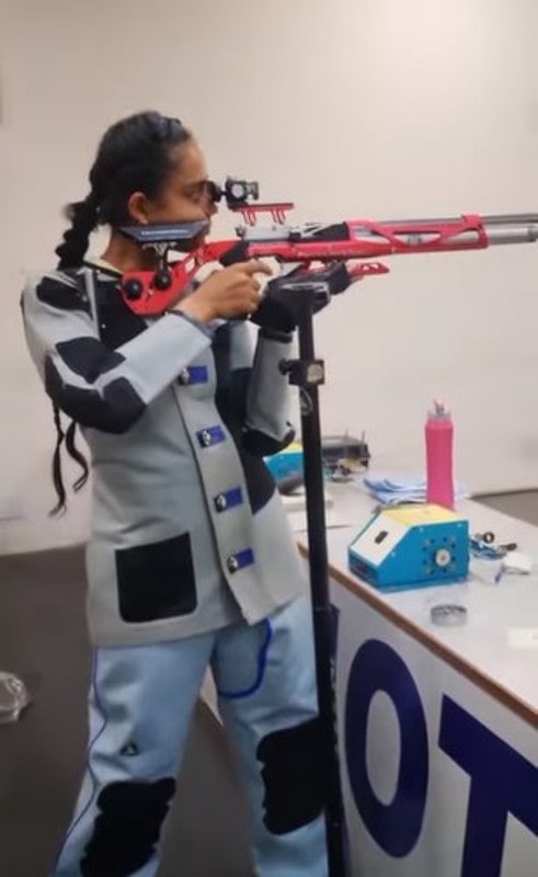 Ishita Shukla practising with a rifle at an indoor shooting range