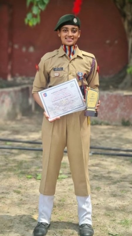 Ishita Shukla holding her Best NCC Cadet Trophy and Certificate after the award ceremony