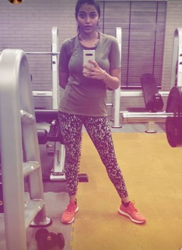 Julie Joglekar posing in a gym