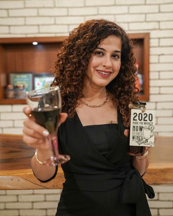 Kamiya Jani holding a glass of wine