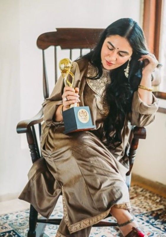 Priya Malik posing with her Outstanding Performance in a Supporting Role Award at the Yellowstone Int Film Festival for her performance in the short film Sheer Qorma (2021)