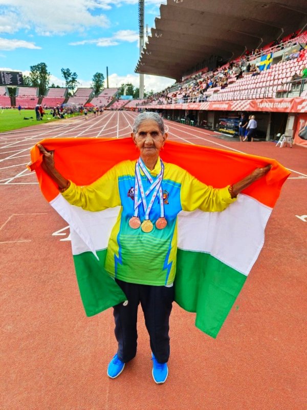 Bhagwani Devi with her medals and the national flag during the World Masters Athletic Championships